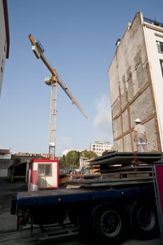 Worker waiting a crane to carry concrete plaks