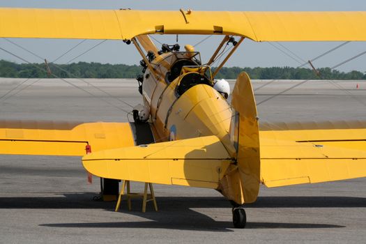 A yellow biplane sitting ready for take-off.