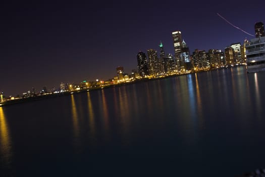 View of city Chicago from the water during sunset and at night
