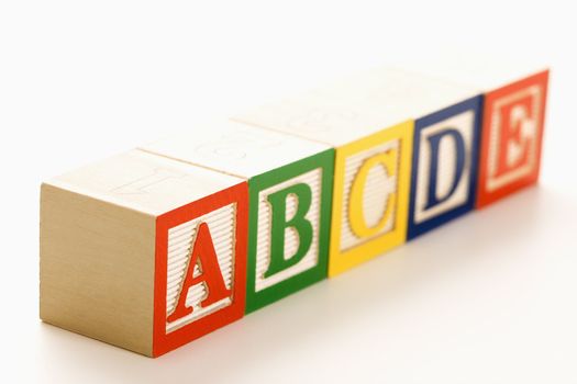 Alphabet blocks lined up in a row.