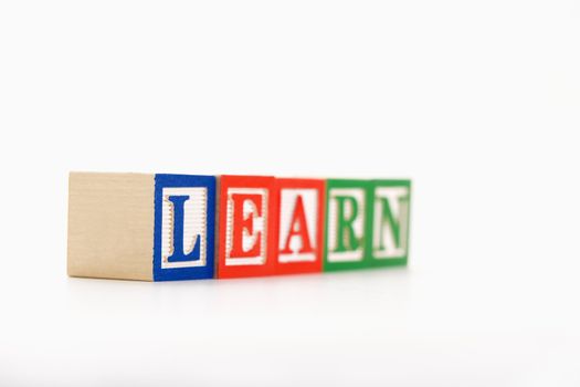 Alphabet building blocks spelling the word learn.