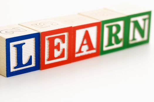 Alphabet toy building blocks spelling the word learn.