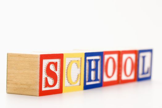 Alphabet toy building blocks spelling the word school.