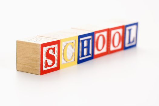 Alphabet toy building blocks spelling the word school.