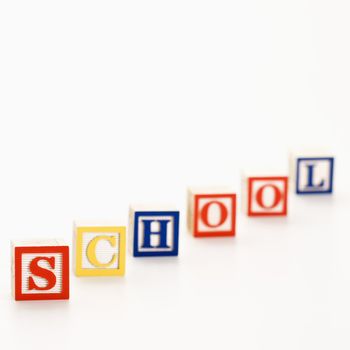 Alphabet toy building blocks spelling the word school.