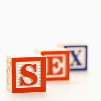 Alphabet toy building blocks spelling the word sex.