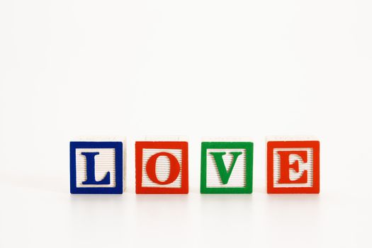 Alphabet toy building blocks spelling the word love.