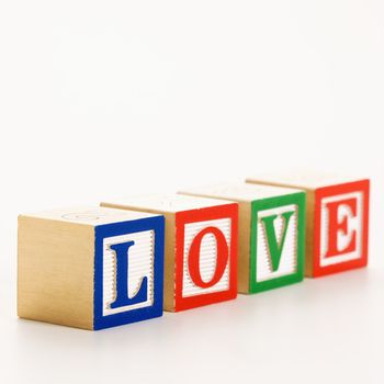 Alphabet toy building blocks spelling the word love.