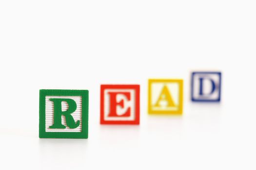 Alphabet toy building blocks spelling the word read.