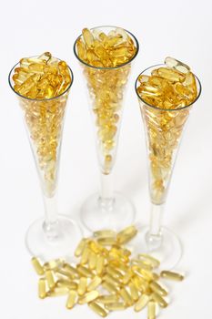 Three glasses with gold shiny boluses