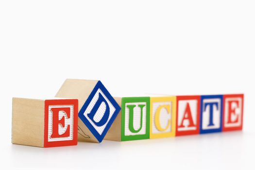 Alphabet toy building blocks spelling the word educate.