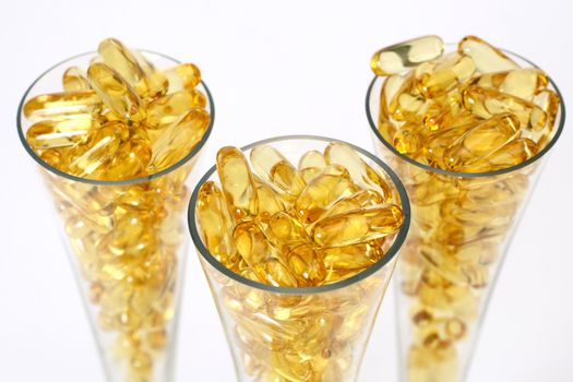 Three glasses with gold shiny boluses