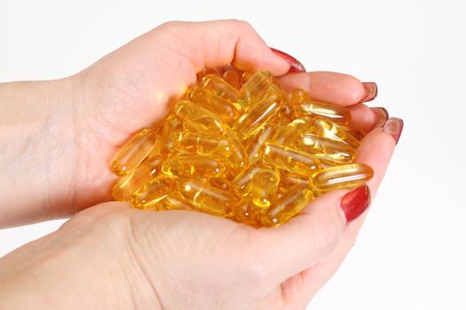 Woman's hands holding gold shiny boluses