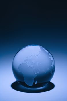 Blue still life of globe showing continents of Europe, Asia and Africa.