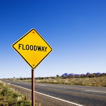 Floodway sign by road in rural Australia.