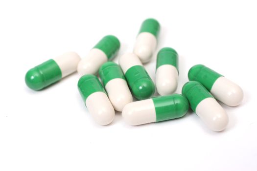 Ten white-green capsules