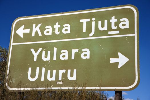 Road sign with direction to Kata Tjuta and Yulara Uluru in Uluru Kata Tjuta National Park, Australia.