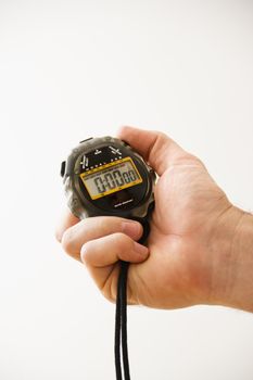 Close-up of adult male hand holding stopwatch.