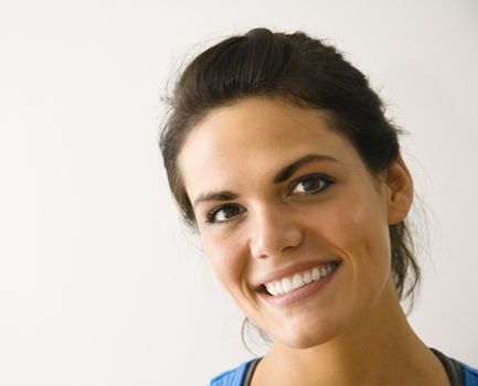 Head and shoulder portrait of woman smiling.