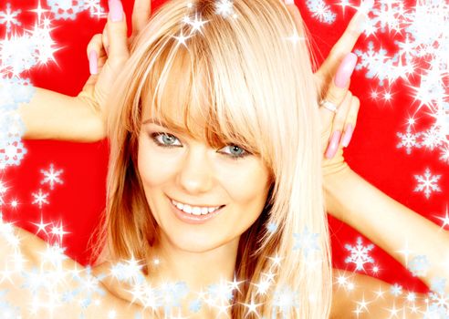 christmas portrait of lovely blond with bunny ears gesture over red