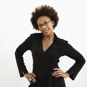 Portrait of woman with afro wearing eyeglasses against white background.