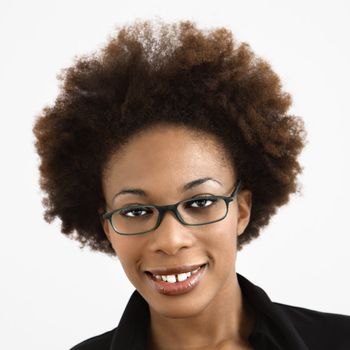Portrait of woman with afro wearing eyeglasses against white background.