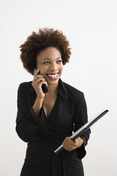 Businesswoman talking on cellphone smiling against white background.