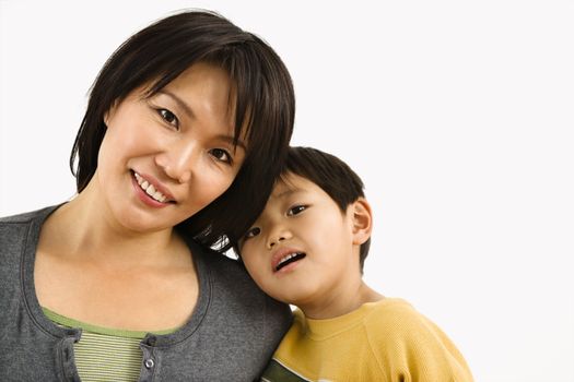 Portrait of Asian mother and young son leaning on eachother.