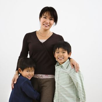 Portrait of Asian mother with two young sons.