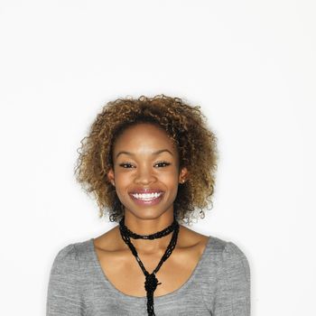 Portrait of pretty young woman smiling on white background.
