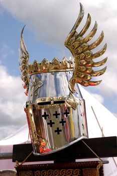 Knightly helmet on a background of the sky