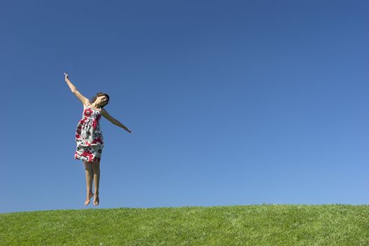 Happy woman having fun on a beautiful green meadow