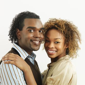 Portrait of smiling couple on white background.