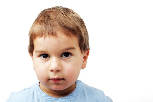 little tranquil serious boy with severe shrill stare 