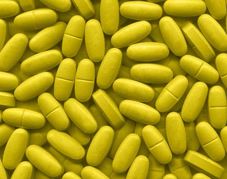 Background made of many yellow pills