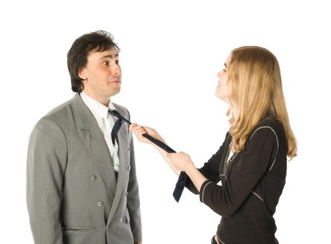 Young pretty woman pulling a man by a necktie