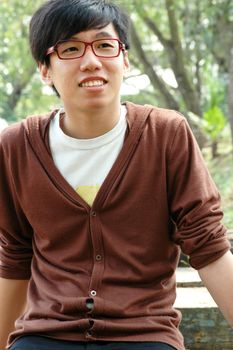 Happy young Chinese male smiling on a summer day