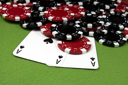 Two black aces over poker many chips