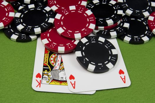 Ace and King heart on poker table chips
