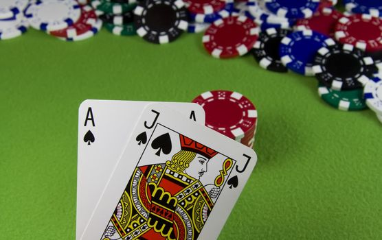 21 Ace and Jack spade over many casino chips