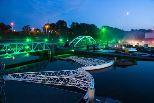 Overview of the miniature city Madurodam, Netherlands, by evening light with waterwaybarrier in the foreground