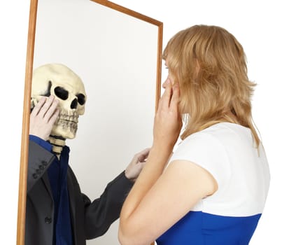 The girl looks into a false mirror isolated on a white background