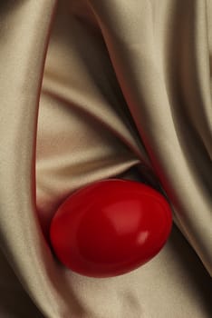 Red chicken egg on silk