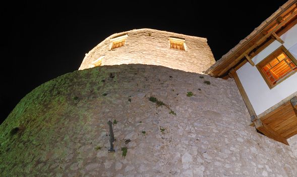 View from below at the west tower in Mostar old town at night.