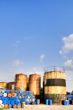 City industrial scenic with factory and tower under blue sky.