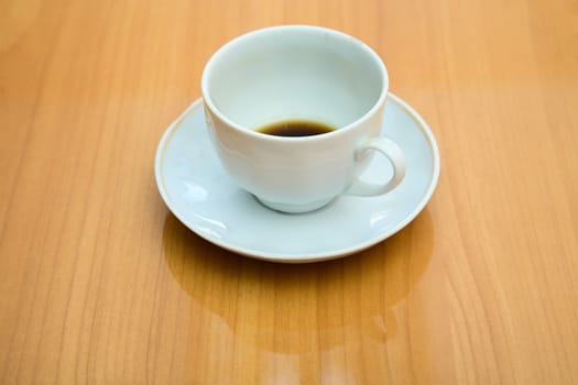 Cup with not drunk up coffee on a table