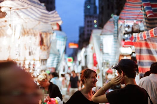 tourists enjoy shopping and experience the night market culture in Temple street of Hong Kong, photo is taken July 08 