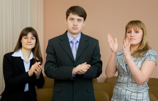 People applaud acting in a conference hall