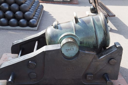 An old bronze cannon that has tarnished
