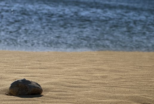 Stones laying on desert or beach sand dunes